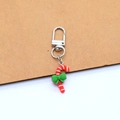 Christmas resin keychain featuring a red and white candy cane with a green bow charm - Candy Cane