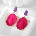 Detail view of pink resin irregular oval earrings with purple droplets and gold metal edges - Large Oval Style