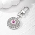 Close-up of pink devil's eye keychain with hollow vintage pattern and crystal rhinestones - Silver Rose Red Eye