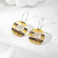 Close-up of geometric resin earrings with wood texture, yellow blocks, and gold foil leaf - Yellow Hollow Round