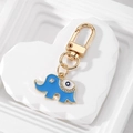Detail of blue elephant keychain with crystals, golden accents, and evil eye charm - Blue Elephant