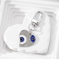 Macro shot of sparkling evil eye heart keychain with blue enamel and crystal rhinestones - Royal Blue Rhinestone Heart Silver