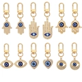 12-delige set gouden Hamsa Hand en Evil Eye sleutelhangers met glinsterende strasstenen - Hoofdafbeelding Stijl (12-Delige Set)