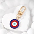 Detail of a bohemian evil eye keychain with vibrant enamel pendant on a white heart stone - 11 Red and Blue Round Keychain
