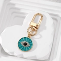 Golden Evil Eye heart keychain with turquoise enamel and sparkling zircon details - Round Peacock Green