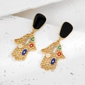 Détail de boucles d'oreilles main de Fatma avec émail coloré et lettrage COCO - Main Hamsa Colorée Grille Dorée (Design COCO)