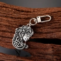 Vintage Medusa head keychain in antique silver finish on natural wood background - Medusa Style
