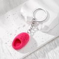 Mini fuzzy rose pink slipper keychain with silver metal ring on a textured white stone base - Slipper / Rose Red
