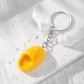Vibrant yellow flocked mini slipper keychain charm on white marble display stand - Slipper / Yellow
