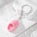 Pink plush mini slipper keychain accessory with silver metal chain on a white stone surface - Slipper / Pink