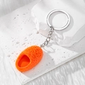 Macro detail of bright orange textured mini slipper pendant with silver metal keyring - Orange