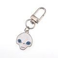 Detail of silver alloy alien keychain with white enamel face and blue eyes charm - Blue-Eyed Alien