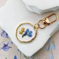 Porte-clés en résine avec fleur séchée bleue et poisson rouge doré dans un cadre rond - Fleur Bleue