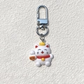 Detail of cute lucky cat keychain with white resin body and golden crown pendant - Beckoning Wealth