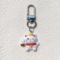 Detailed view of white resin Maneki Neko keychain with golden ingot and lobster clasp - Fortune