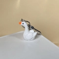 Detail view of a white resin goose keychain with an orange beak and silver metal ring - Swan (Goose Style)