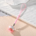 Close-up of pink Maneki-neko cat charm with golden Fortune text and braided cord - Pink