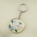 Detail of handmade resin keychain with real dried white flowers and butterfly charms - Three Butterflies with Floral