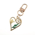 Golden heart keychain pendant featuring real yellow dried flowers and a green leaf - Green Leaves Yellow Flowers