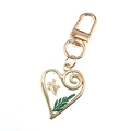 Golden heart-shaped keychain featuring real white dried flowers and green fern leaves - Green Leaf Floral