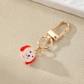 Portachiavi cane cartone animato con chiusura in metallo dorato su fondo beige - Cane con Orecchie Rosse
