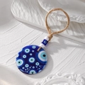 Detailed close-up of large blue acrylic Evil Eye pendant with hemp rope and glass beads - Multi-eye Pattern(9#)