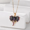 Ethnic golden elephant pendant necklace with colorful zircon stones on white background - Black Elephant Style