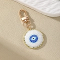 Ethnic style Evil Eye and gold heart keychain pendant with blue enamel on sandy background - Round Dark Blue Round Eye