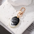 Portachiavi bohémien con ciondolo in resina effetto marmo bianco e nero e gancio d'oro - Ovale Nero Bianco