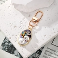 Vintage gold keychain with purple oval pendant featuring a large pearl and sparkling rhinestones - Deep Purple Pearl