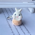 Detail of cute flocked white bunny in orange pumpkin figurine with metal keyring hook - Pumpkin Rabbit