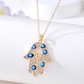 Golden Hamsa hand pendant necklace with sparkling white rhinestones and blue evil eye charms - Gold Full Rhinestone Hollow Hand