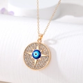 Macro shot of gold Evil Eye pendant with sparkling rhinestones and blue amulet charm - Four-Pointed Star Evil Eye Style (AN200)