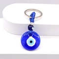 Turkish Blue Evil Eye Keychain with glass pendant and braided rope on white display - Round
