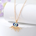 Close-up of heart devil eye pendant necklace with blue enamel and golden rays - Gold Explosion Eye
