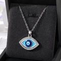 Detailed close-up of retro evil eye square pendant with blue enamel and rhinestones - Silver Rhinestone Eye