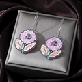 Detail view of pink acrylic flower earrings with green leaves on a jewelry box - Pale Purple Floral
