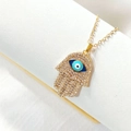 Gold Hamsa necklace with full zircon pavé and blue evil eye charm on white display - Blue Evil Eye Hamsa Style (AN200)
