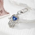 Hamsa hand keychain with blue heart evil eye charm and silver metal finish - Silver Hollow Hamsa Hand / Silver Heart Eye