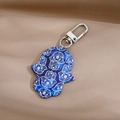 Detailed view of bohemian Hamsa keychain with retro pattern on beige satin background - 13# Dark Blue Palm