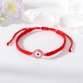 Handmade red braided evil eye bracelet with adjustable cord and pink accent charm - Pink And White Round Eye