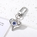 Detail of silver heart-shaped evil eye keychain with blue pupil and lobster clasp - Heart Shape Purple Eye Silver