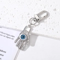 Detailed macro view of the silver Hamsa hand keychain with a blue evil eye and lobster clasp - Hamsa Hand Blue Eye Silver