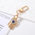 Portachiavi Mano di Fatima e Occhio del Male in metallo dorato con perla blu e gancio - Mano di Fatima Occhio Grigio Oro