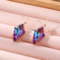 Elegant geometric iridescent crystal leaf earrings with gold hooks on a pink jewelry tray - Purple