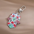 Hamsa Hand keychain with colorful floral patterns and silver spring clasp on silk - Green Leaves and Red Flowers