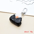Detail view of a realistic resin onigiri rice ball keychain with seaweed and silver clasp - Triangle Rice Ball