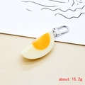 Detailed view of boiled egg resin keychain showing white and orange realistic textures - 1/4 Egg