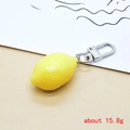 Detailed view of 15.8g lifelike lemon keychain with textured resin skin and silver D-buckle - Lemon