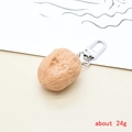 Detailed view of realistic walnut keychain made of resin with silver metal clasp - Walnut
